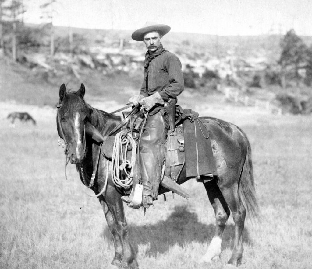 Cowboy wearing cuban heels on horseback.
