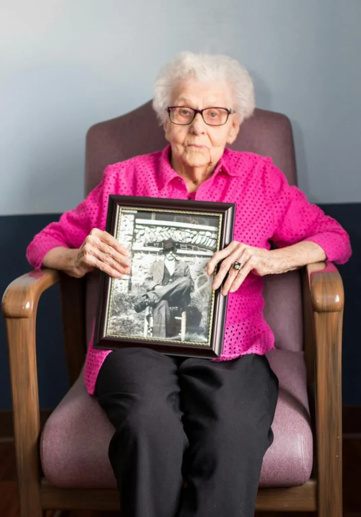 Helen Jackson sits with portrait of her husband, a Civil War Veteran. Image from cherryblossomfest.com​
