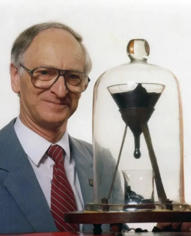 Professor John Mainstone with the Pitch Experiment in 1990. This is the 8th drop being formed in the picture. 