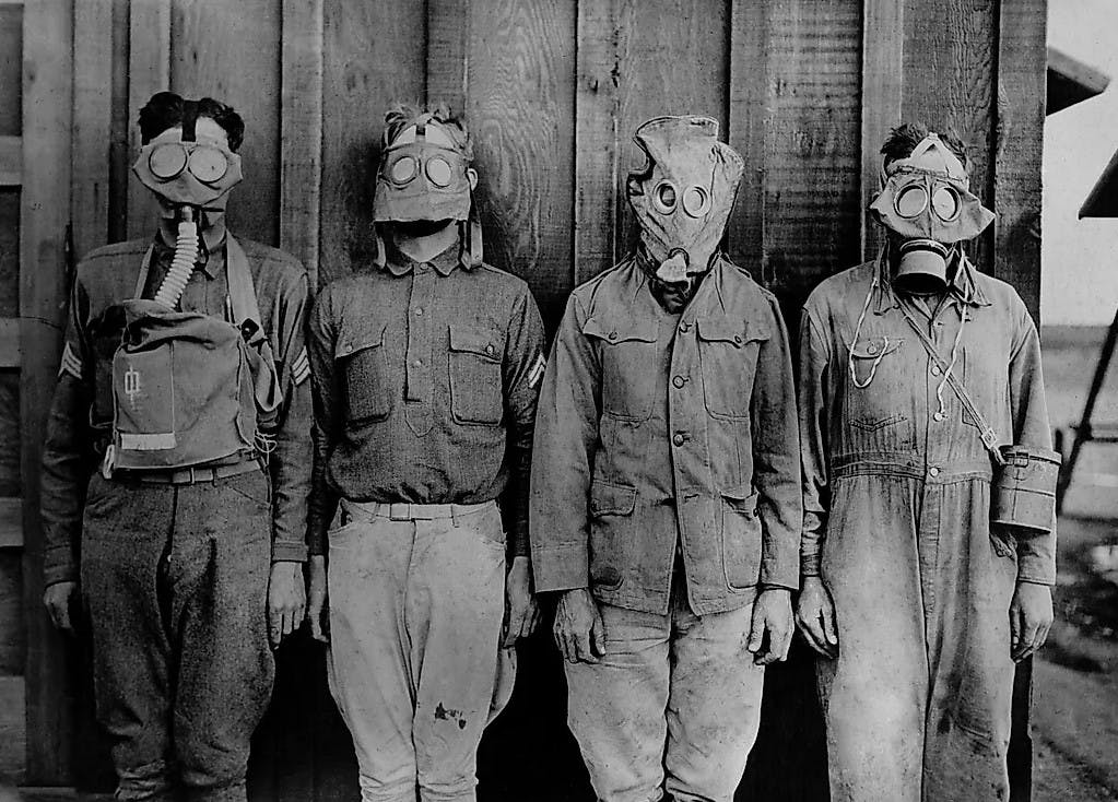 Soldiers wearing WW1 gas masks
